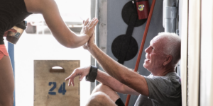 two workout partners high fiveing during a workout showing wellness activities