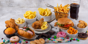 a table full of junk food showing how bad diet can affect healthy sleep habits