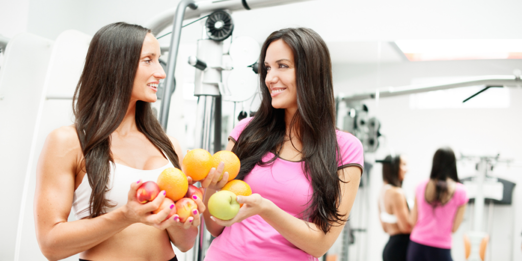 a nutrition and wellness coach helping an athlete in the gym